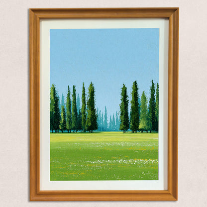 A straight-on view of a framed art print showing an oil painting texture of a lush green meadow with tall, dark green Cypress trees against a pale blue sky, displayed in a natural wood frame on a light-colored, textured wall.