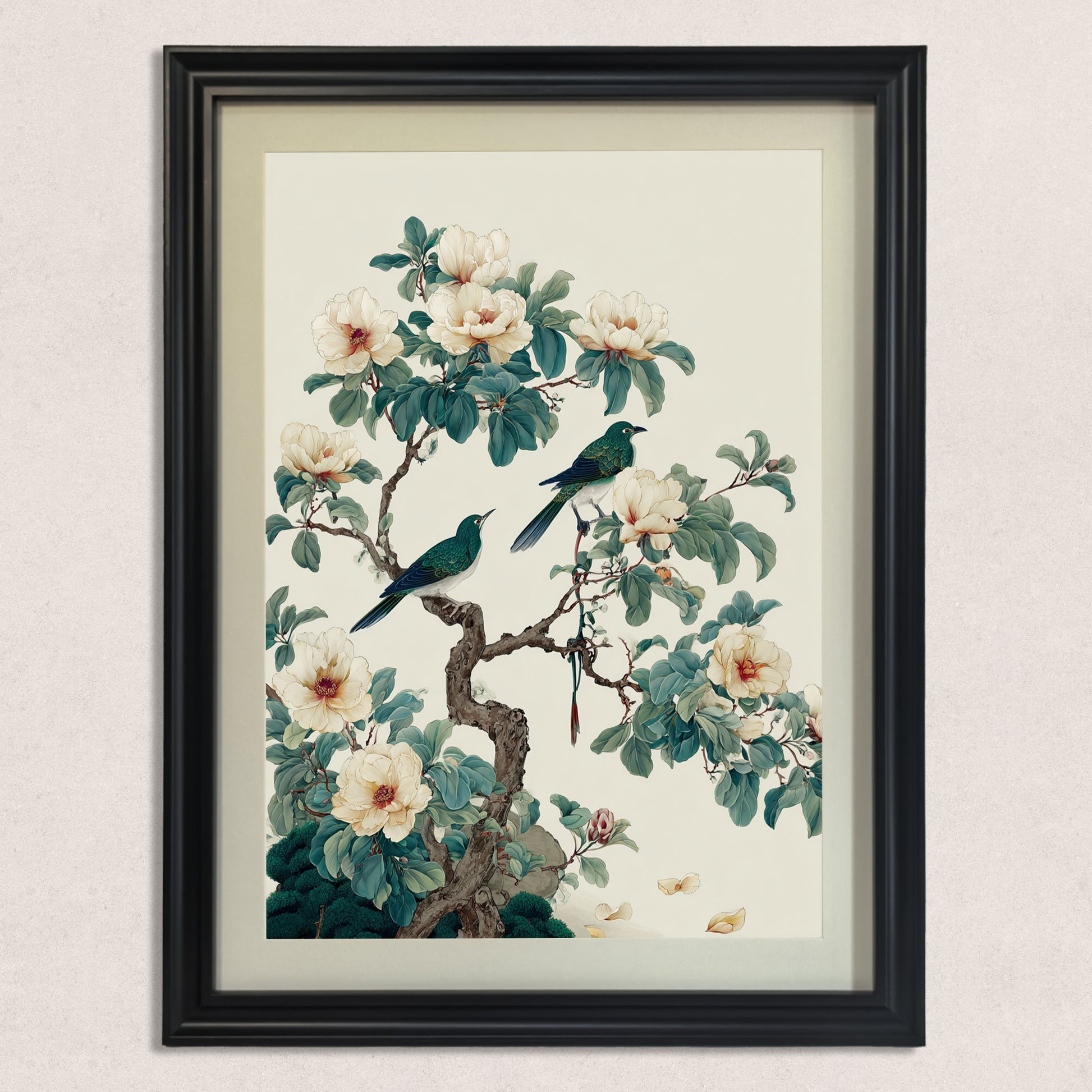 A straight-on studio shot of a vertical black framed art piece featuring an illustration of two teal birds perched on a flowering branch with large white blossoms.