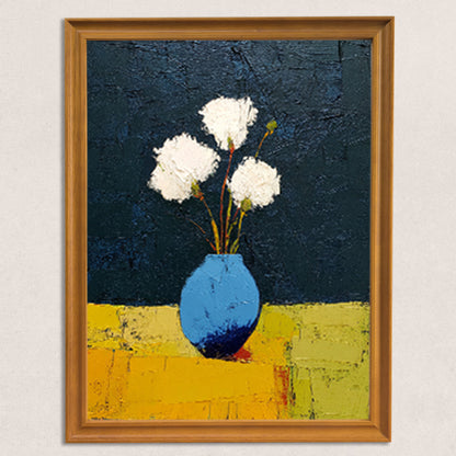 Close-up of the art print itself: abstract painting of three white textured flowers in a blue vase on a yellow surface with a dark blue background, framed in a light brown wood frame.