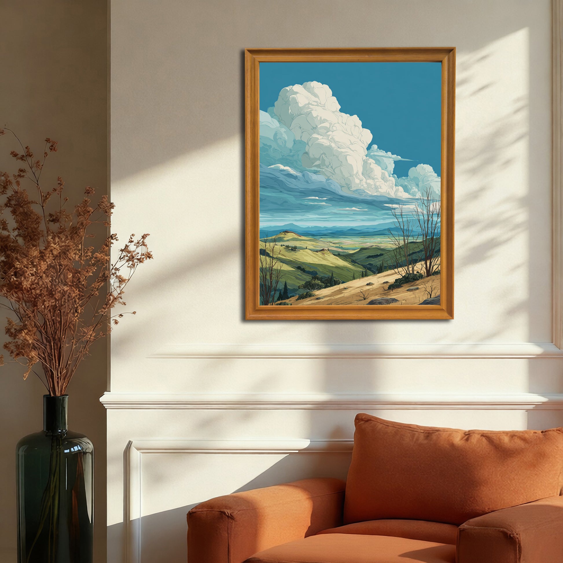 Rolling hills landscape art print in a gold or dark natural wood frame hanging above an orange armchair and white wainscoting, illustrating a luxurious, traditional living room decor.