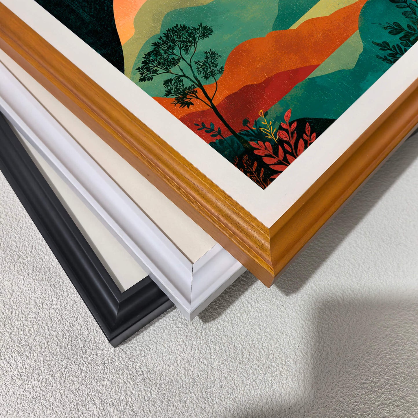 Close-up corner detail of the art print showing three stacked frame options: , white, orange, and black.