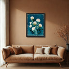 A black-framed art print hanging on a warm terracotta-colored wall above a brown velvet sofa. The floral artwork is a high-contrast piece with white and green elements set against a rich blue-teal.