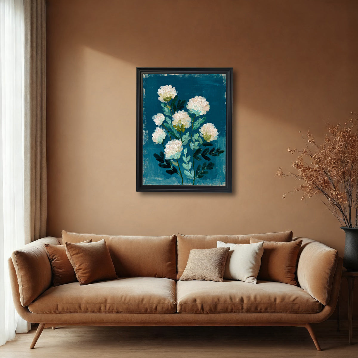A black-framed art print hanging on a warm terracotta-colored wall above a brown velvet sofa. The floral artwork is a high-contrast piece with white and green elements set against a rich blue-teal.