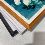A stack of four frame corners: black, off-white, white, and a light wood grain (brown). This displays the available framing options for the abstract white floral art print.