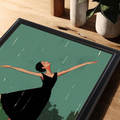 A close-up, angled shot of the framed art print, with the black frame and a portion of the dancing woman visible on a wooden table.