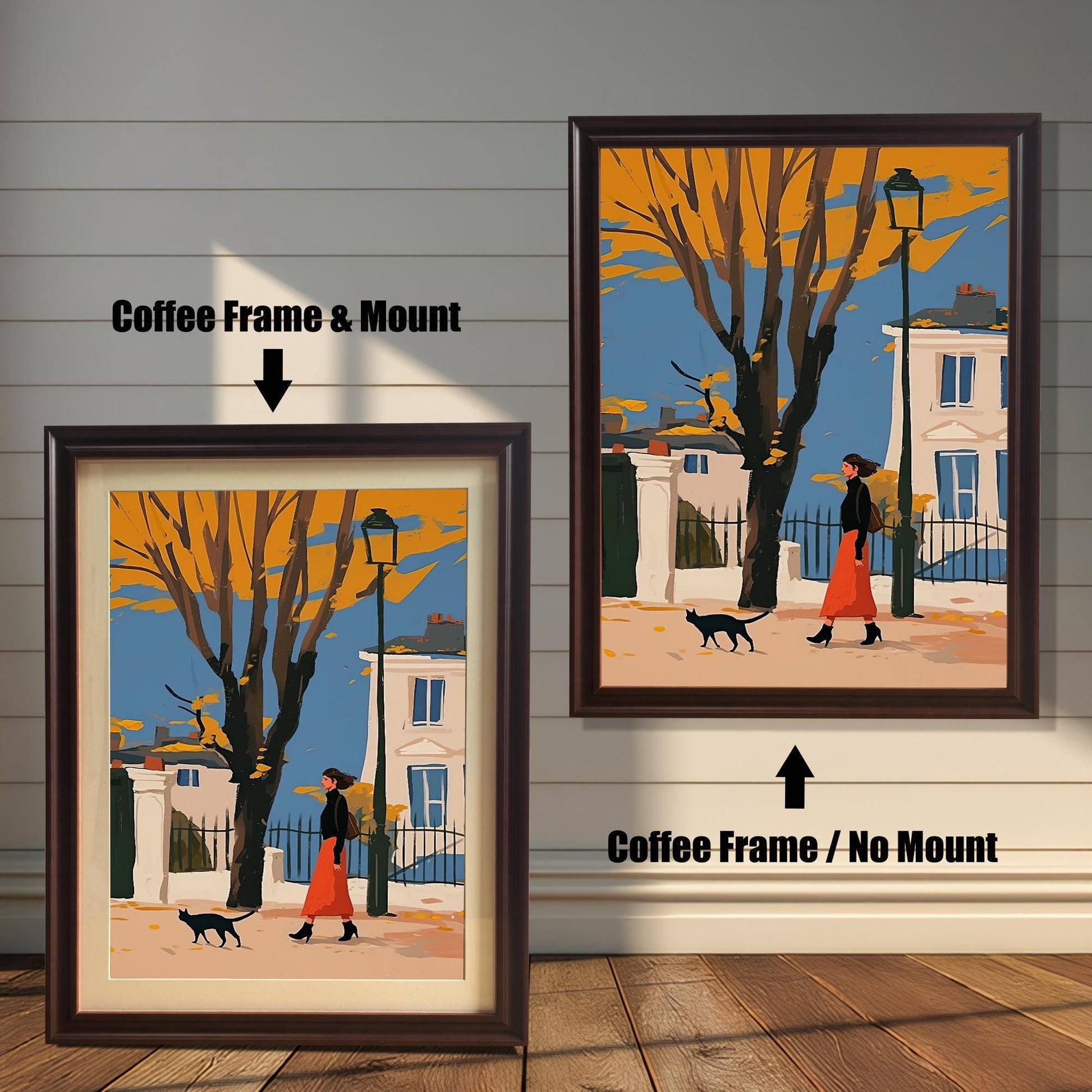 Two framed art prints of a woman and a black cat walking on a street. The left print has a coffee-colored frame and a white mat ("mount"), while the right print has a coffee-colored frame with no mat.