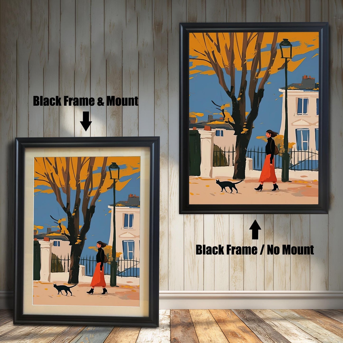 Two framed art prints of a woman and a black cat walking on a street. The left print has a black frame and a white mat ("mount"), while the right print has a black frame with no mat.