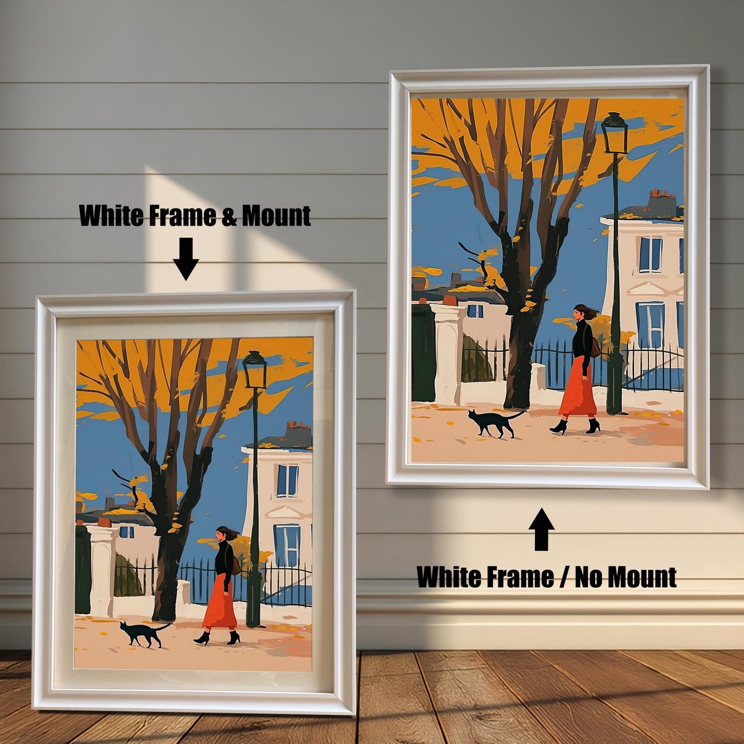 Two framed art prints of a woman and a black cat on a street. The left print has a white frame and a white mat ("mount"), while the right print has a white frame with no mat.
