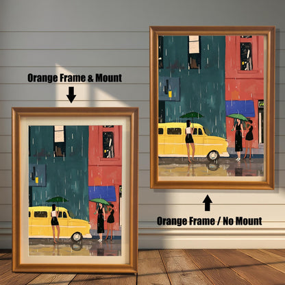 A split image showing two different framing options for the same artwork. On the left, a framed print with an orange wood-tone frame and a white mat (mount) is labeled "Orange Frame & Mount." On the right, the same print is shown in an orange wood-tone frame without a mat, labeled "Orange Frame / No Mount." Both images are against a rustic wood-paneled wall. The art depicts a street scene with a yellow bus and three women with umbrellas in the rain.