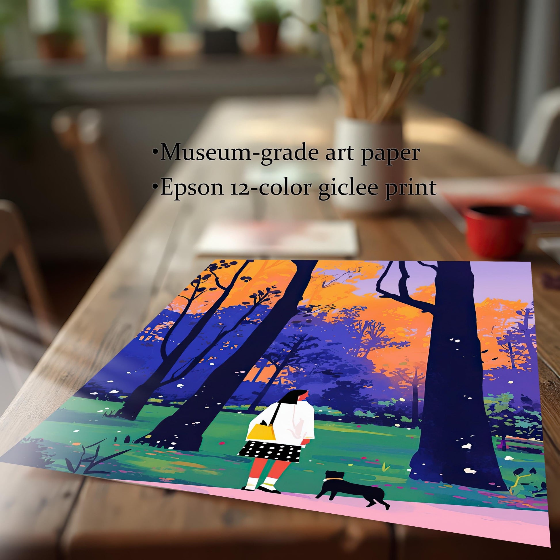 A close-up shot of an unframed art print lying on a rustic wooden table. The art depicts a woman and a small black dog walking through a park with colorful trees. Text on the image highlights the quality of the print: "Museum-grade art paper" and "Epson 12-color giclee print."