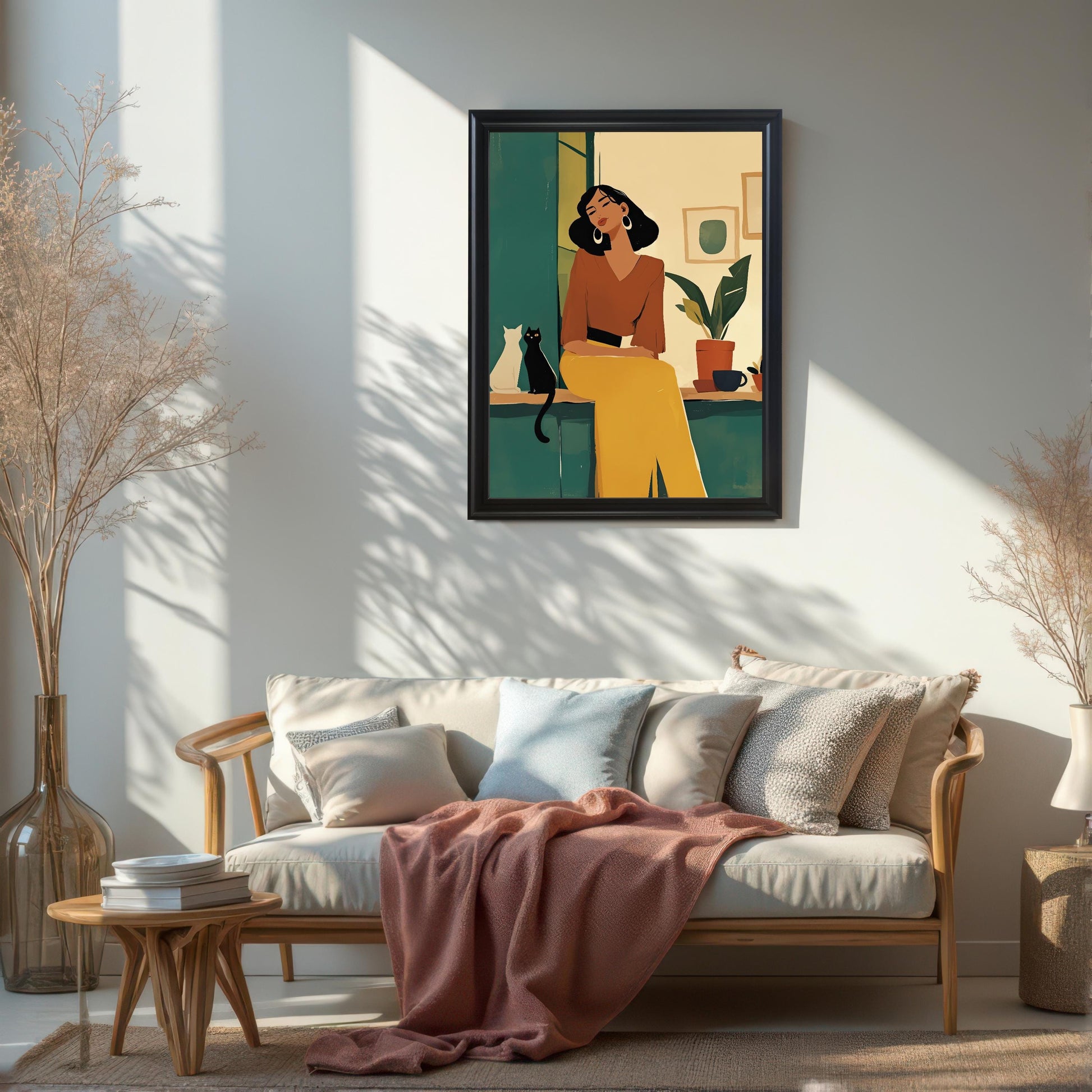 Large black framed wall art print of a woman and a cat hanging on a white wall above a beige sofa. This modern framed art print is perfect for Scandinavian, minimalist, or bohemian home decor.