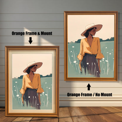 Orange wood framed wall art print of a woman in a field with a hat. Two options shown: a large print without a matboard and a smaller print with a white matboard. Modern portrait for home decor.