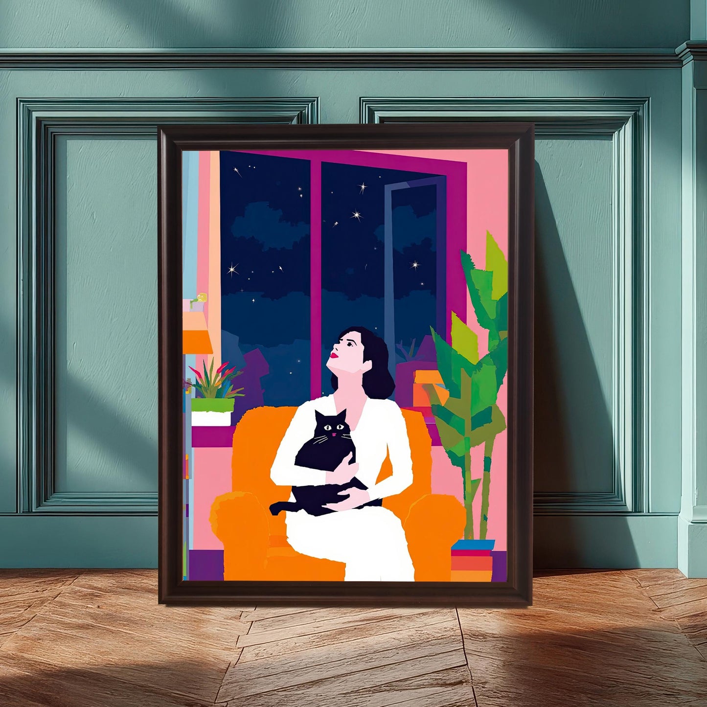 A large wall art print with a black wood frame, leaning against a teal paneled wall. The artwork, featuring a seated woman and a cat looking at the stars, contrasts beautifully with the wall color, creating a stylish and inviting interior design.