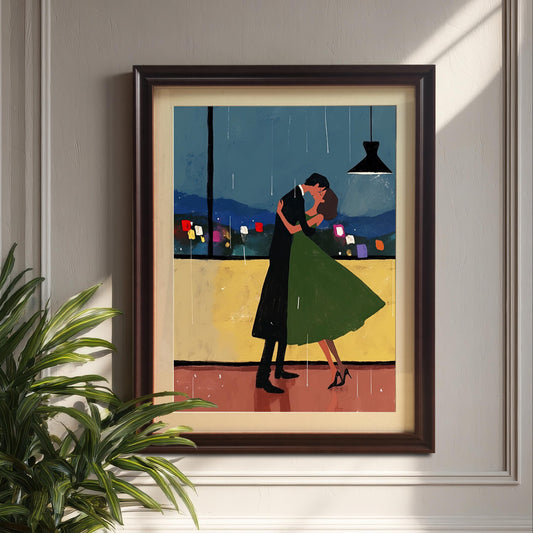 A wall art print with a coffee-colored frame is hanging on a paneled white wall, with sunlight casting a shadow across the artwork. A large green potted plant is in the foreground to the left. The painting depicts a couple dancing in the rain with a city view in the background.