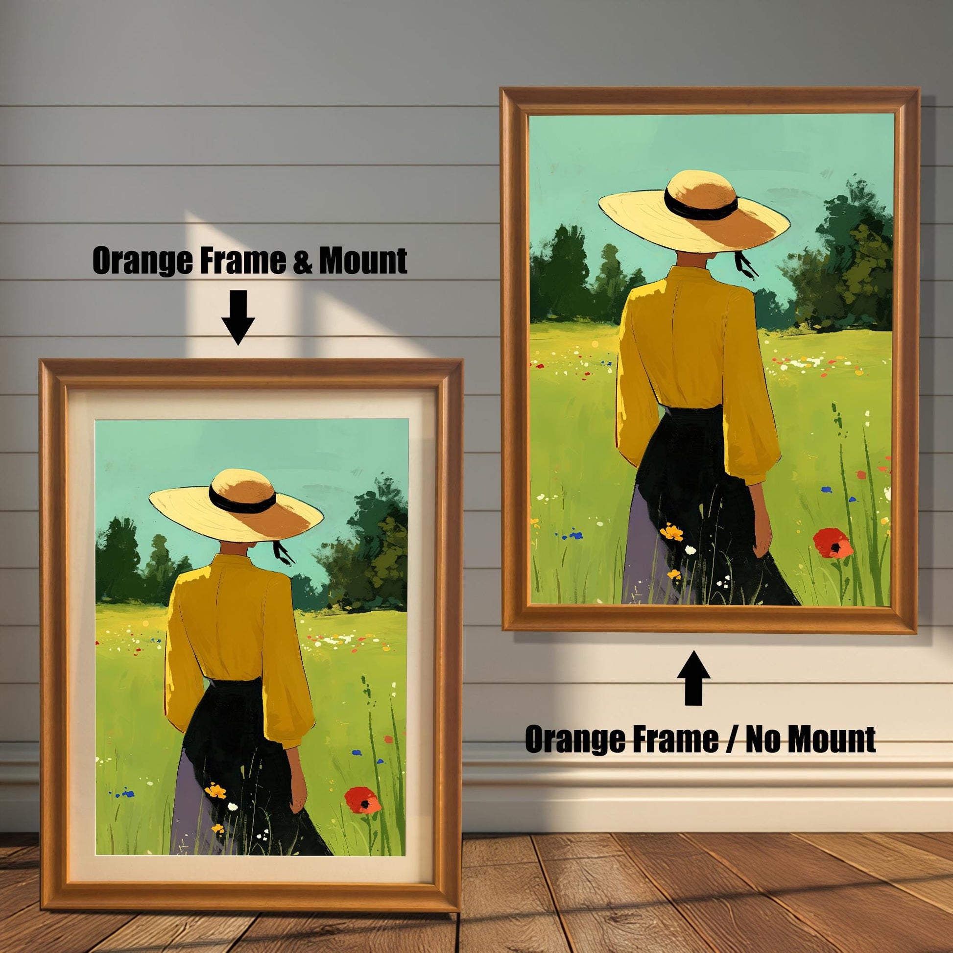 A split-view image showing two framed art prints against a white wood-paneled wall. The left print has an orange frame and a white mount, with a black arrow pointing to it and text that says "Orange Frame & Mount." The right print has the same orange frame but no mount, with a black arrow pointing up to it and text that says "Orange Frame / No Mount." Both prints show the same image of a person in a yellow shirt and straw hat standing in a grassy field.