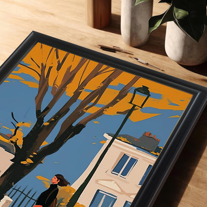 A close-up, angled view of a framed art print showing a woman and a black cat walking on a city street in autumn.
