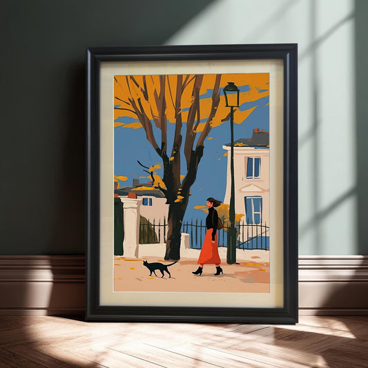 A framed art print of a person in a red skirt walking with a black cat on an autumn street, propped against a dark wall.