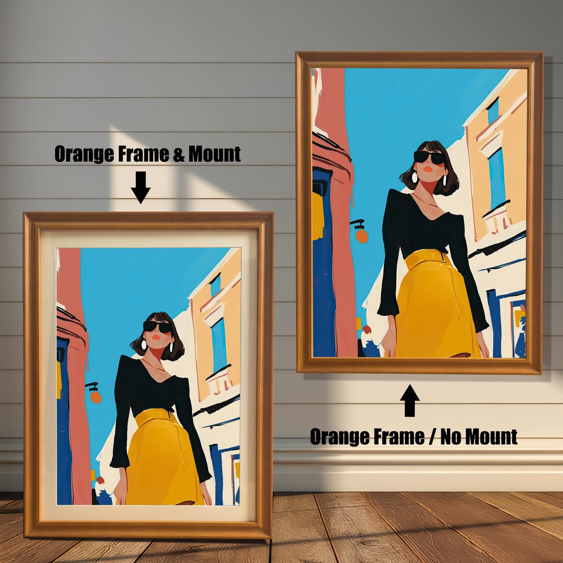 A split image showing two different framing options for the same artwork. On the left, a framed print with an orange wood-tone frame and a white mat (mount) is labeled "Orange Frame & Mount." On the right, the same print is shown in an orange wood-tone frame without a mat, labeled "Orange Frame / No Mount." Both images are against a rustic wood-paneled wall. The art depicts a stylish woman in a black shirt and yellow skirt standing on a street.