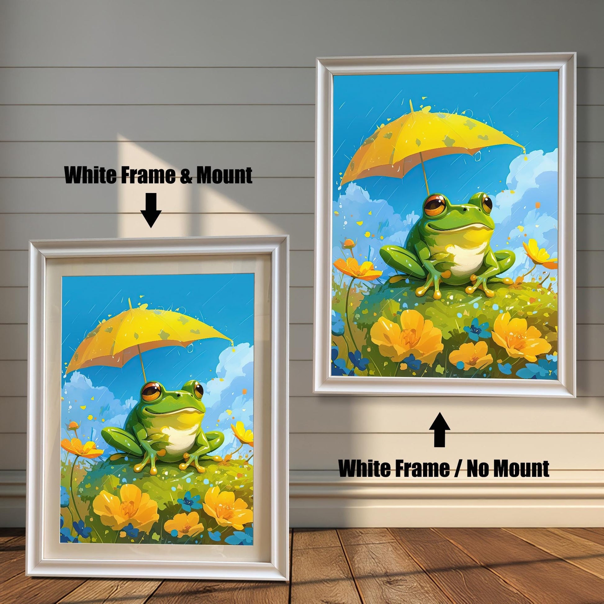 Two white-framed art prints of a cute frog with a yellow umbrella. The print on the left has a white mat (mount) for a clean, classic look, while the one on the right is a full-frame display. Both pieces are leaning against a white wood paneled wall.