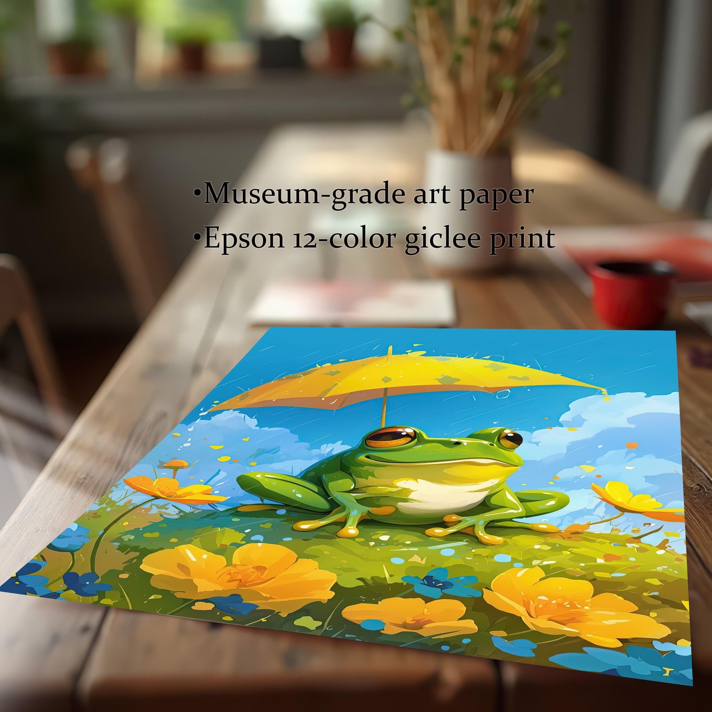 A vibrant, unframed art print of a cute frog with a yellow umbrella, resting on a rustic wood dining table. The image highlights the high-quality printing process, noting it's a "Museum-grade art paper" and an "Epson 12-color giclee print."
