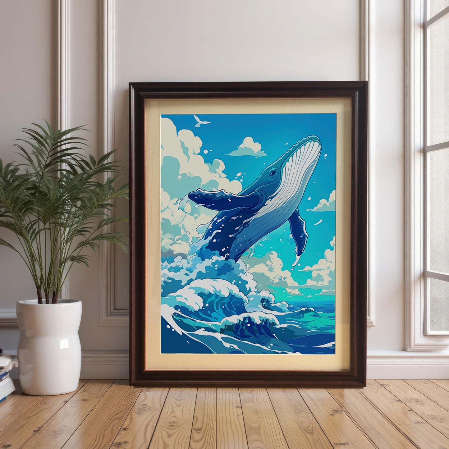 The framed whale art print leaning against a wall on a wooden floor, staged next to a decorative houseplant.