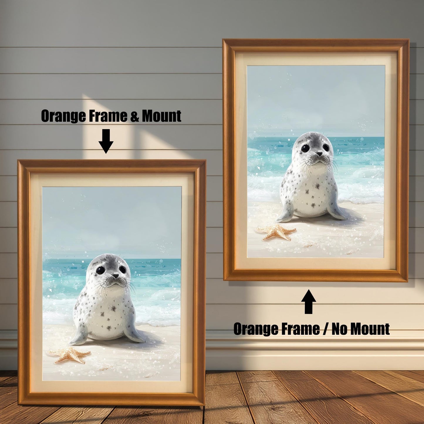 Two framed wall art prints of a baby seal on a beach. The one on the left has an orange frame and a mount, and the one on the right has an orange frame but no mount. Text labels each option.