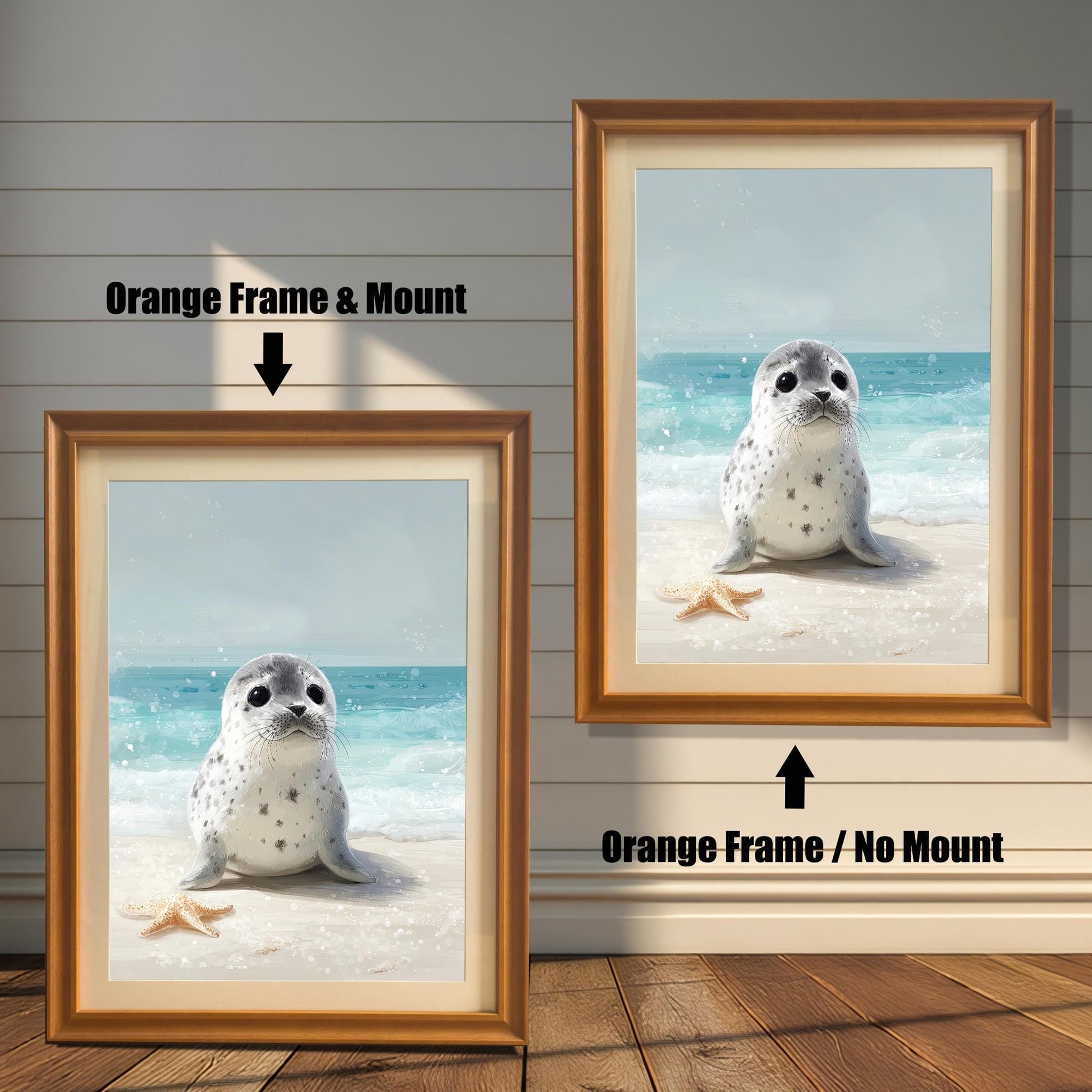 Two framed wall art prints of a baby seal on a beach. The one on the left has an orange frame and a mount, and the one on the right has an orange frame but no mount. Text labels each option.