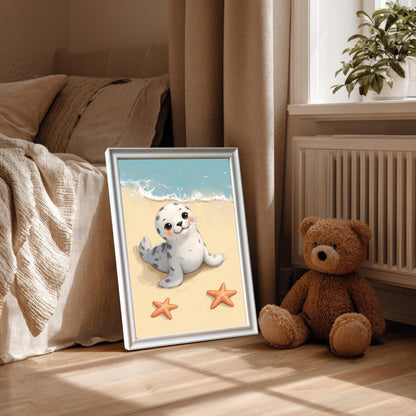 A framed wall art print of a cute baby seal on a beach, with a mount and a white frame. The print is propped on the floor next to a bed and a teddy bear, bathed in natural light.