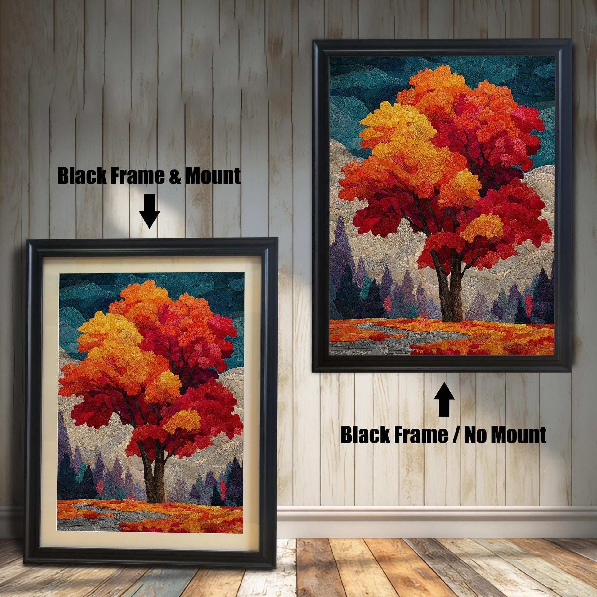 Two framed prints of an autumn tree stand on a wooden floor against a white paneled wall. The one on the left has a black frame with a mount (mat), and the one on the right has a black frame without a mount.