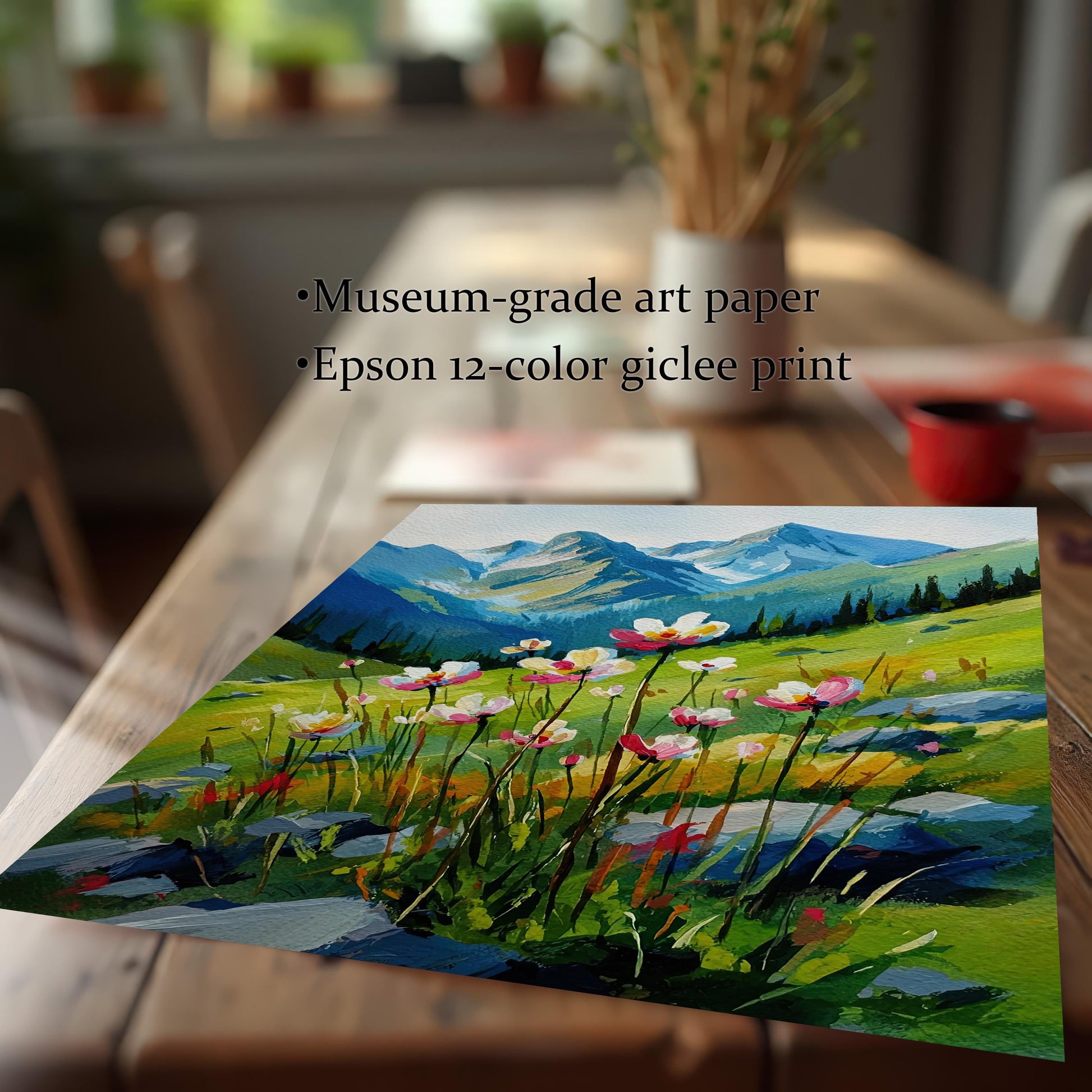 A low-angle shot of a landscape painting of a field of flowers and mountains, shown on a rustic wooden table. Text overlays highlight its features: "Museum-grade art paper" and "Epson 12-color giclee print."