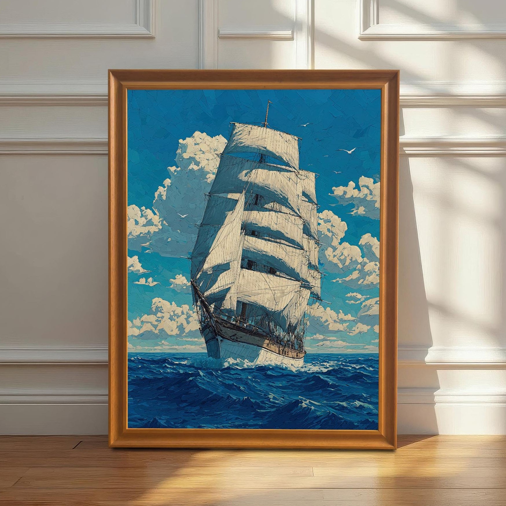 A framed painting with a golden frame and a mat board is leaning against a white wainscoted wall. The painting shows a tall ship sailing on a blue sea under a cloudy sky.