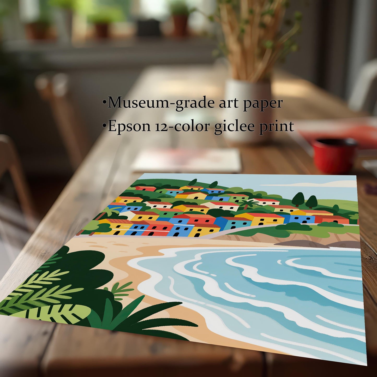 A close-up, angled view of a print showing a colorful village on a hill overlooking a beach. The text lists "Museum-grade art paper" and "Epson 12-color giclee print" next to the print.
