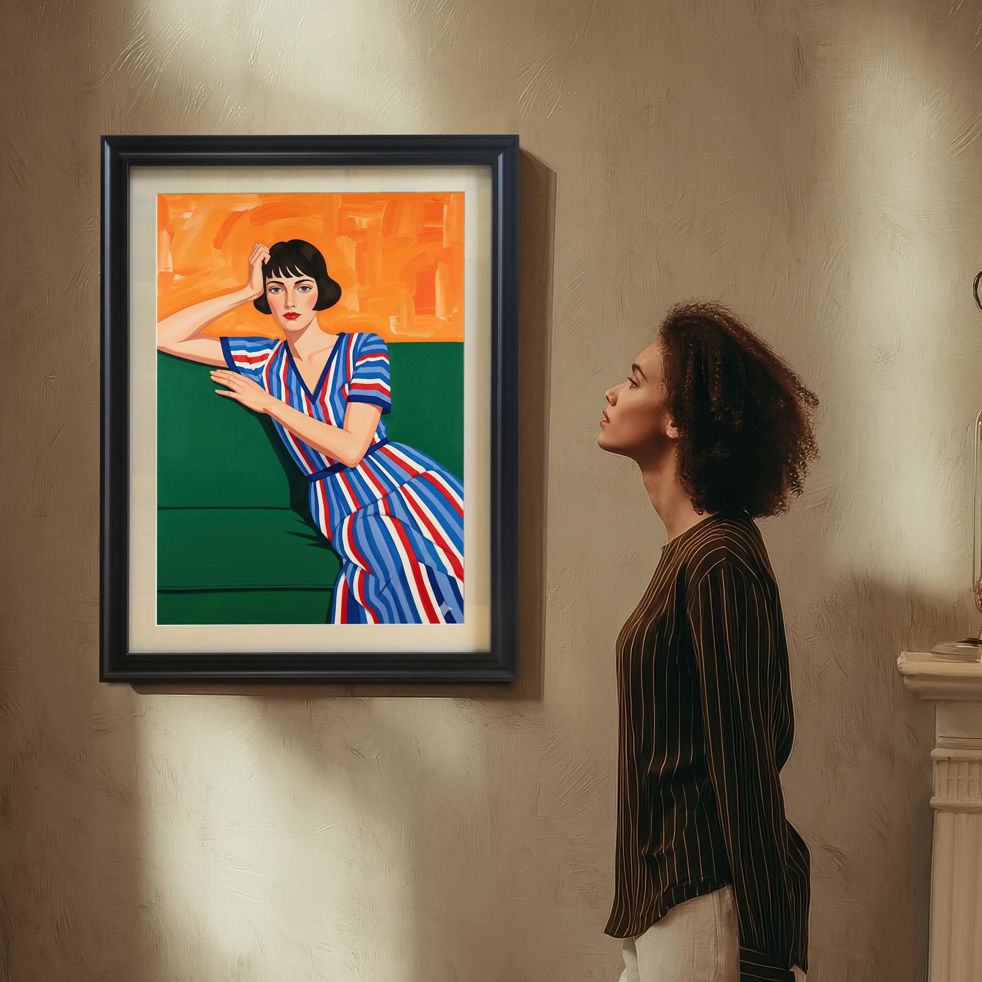 A woman with curly hair, wearing a striped shirt, looks up at a black-framed art print of a seated woman. The print hangs on a textured wall above a fireplace mantel.