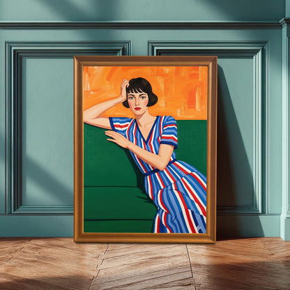 A large art print of a seated woman with a striped dress is propped on a wooden floor in front of a teal wall with decorative molding. The frame is a light orange wood tone.
