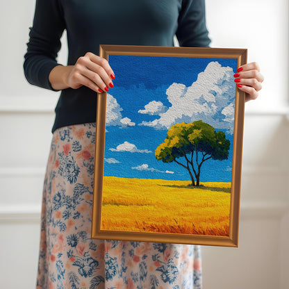 A person in a black long-sleeve shirt and a floral skirt holds an orange-brown wood-framed print of a tree in a field.