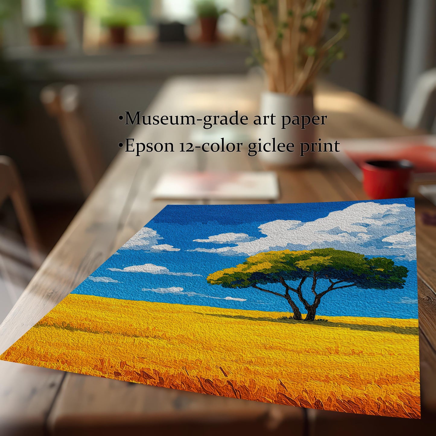 Close-up of a print of a tree in a field lying on a wooden table. The text highlights "Museum-grade art paper" and "Epson 12-color giclee print."