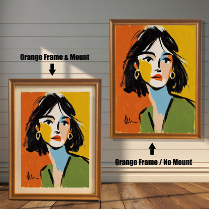 An abstract portrait of a woman is shown in two orange-colored frames against a rustic wood wall. One has a mount, the other does not.