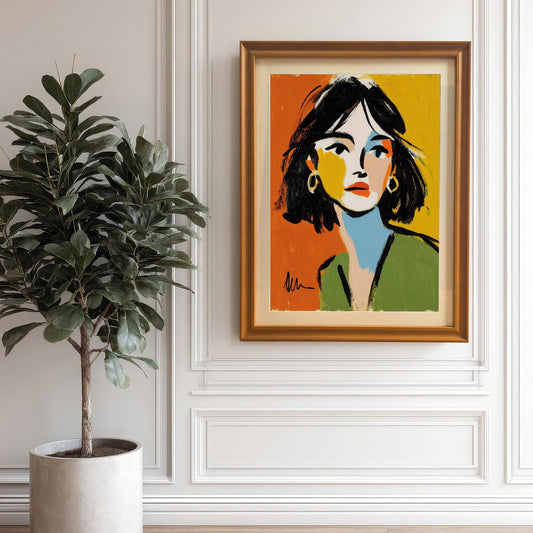 An abstract portrait of a woman in a gold frame hangs on a white paneled wall next to a large potted plant.