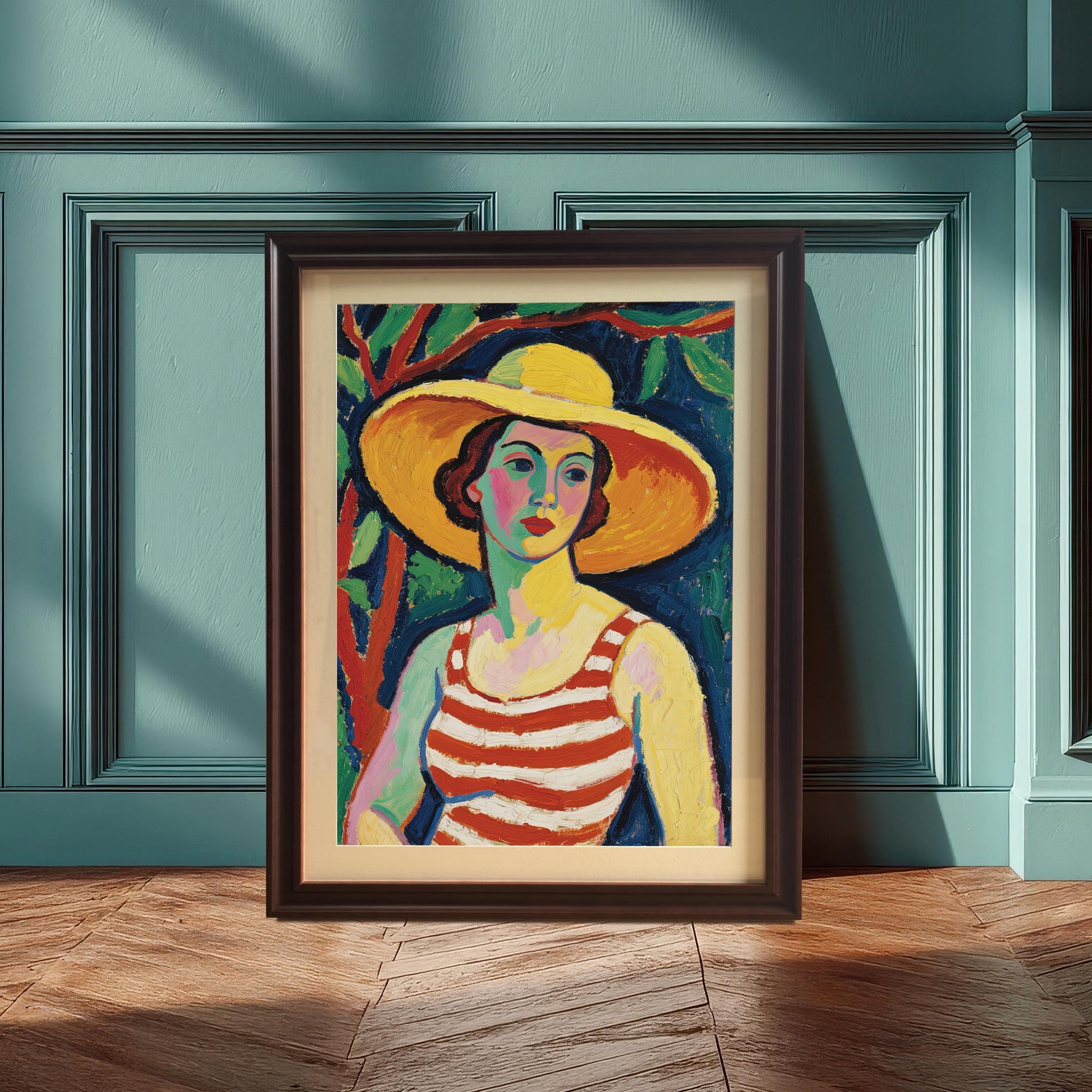 A framed art print of a woman in a striped top and yellow hat, propped against a dark blue-green wall with wainscoting. The frame is coffee-colored.