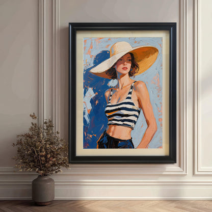 A framed art print featuring a woman in a striped top and sun hat, propped against a white paneled wall with a plant on the floor next to it. The frame is black.