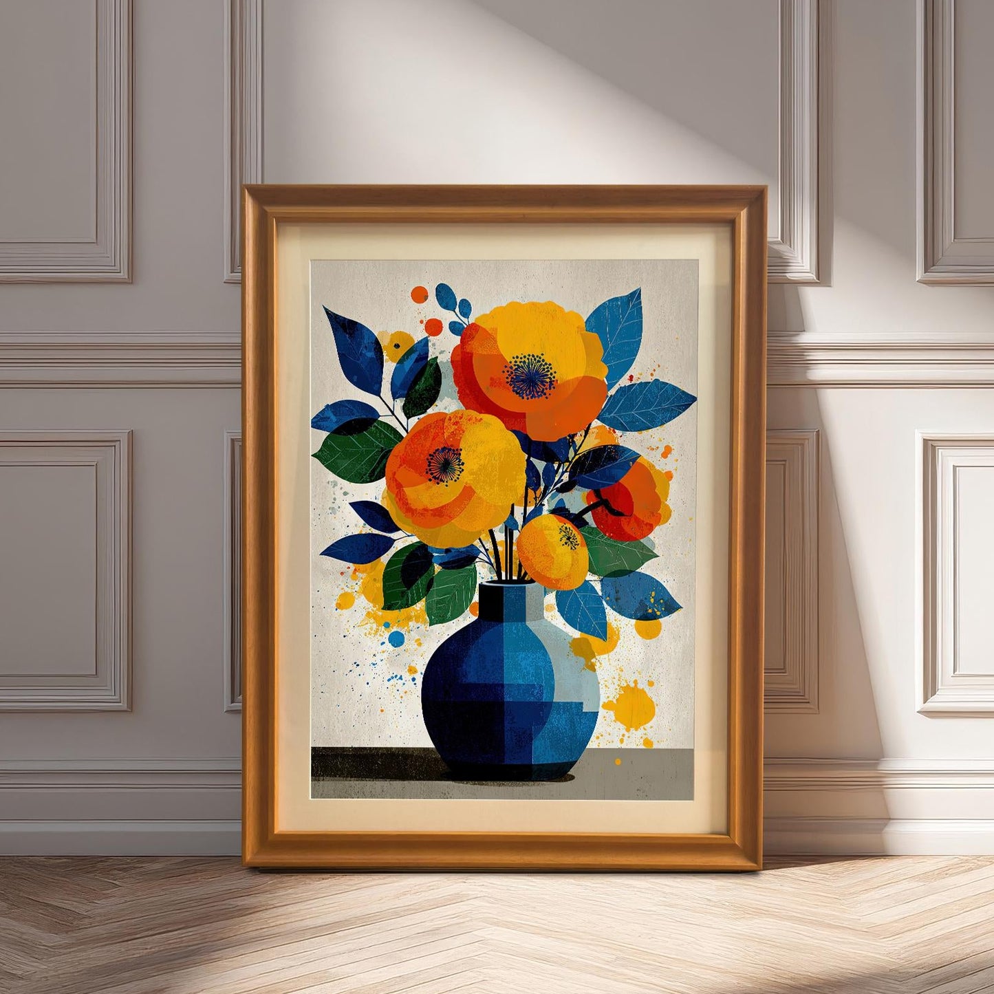 An orange-framed painting of a floral arrangement in a blue vase is propped up on a wooden floor in front of a white wall with decorative molding.