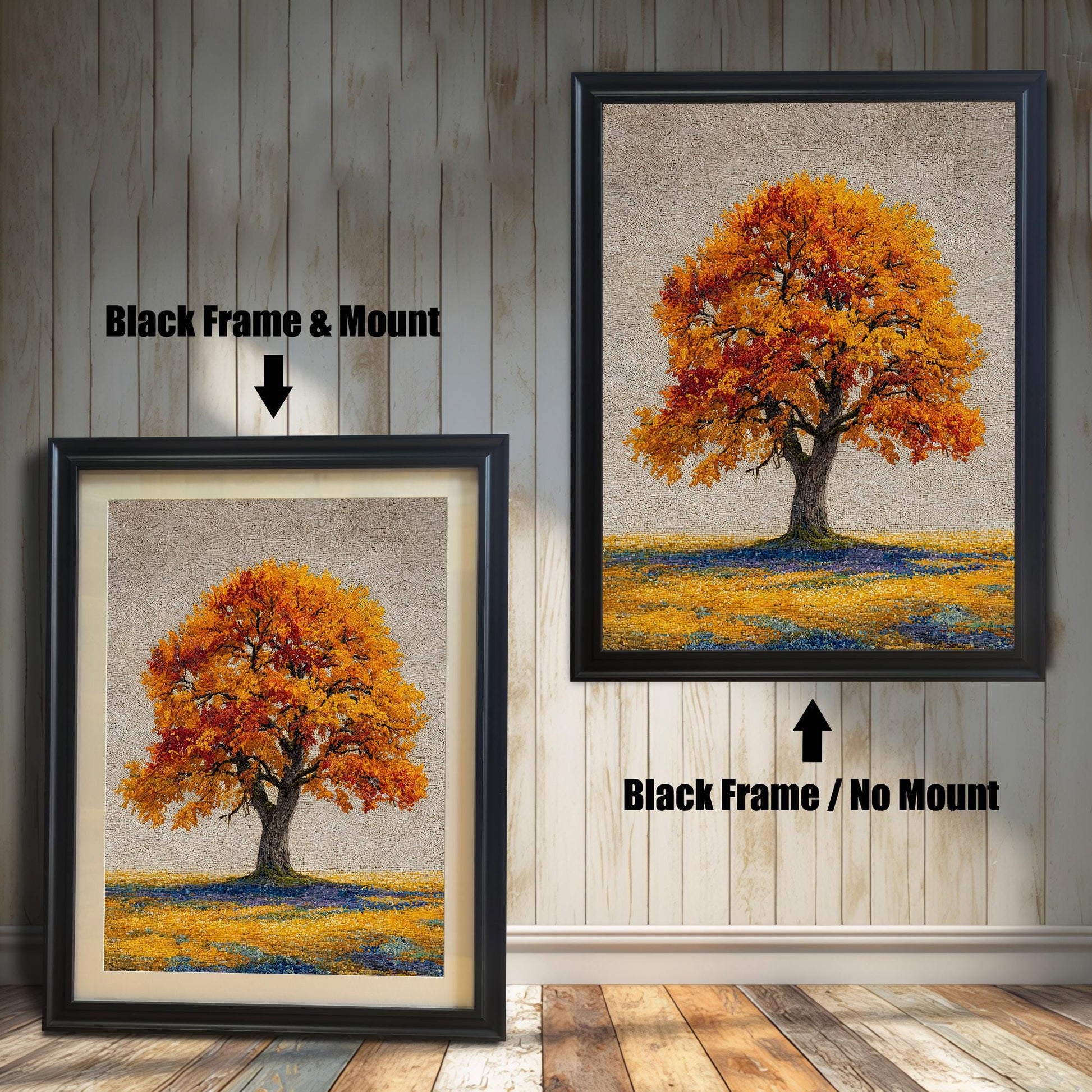 Two framed art prints of an autumn tree are on a wooden floor. The print on the left is in a black frame with a mount, and the one on the right is in a black frame without a mount.