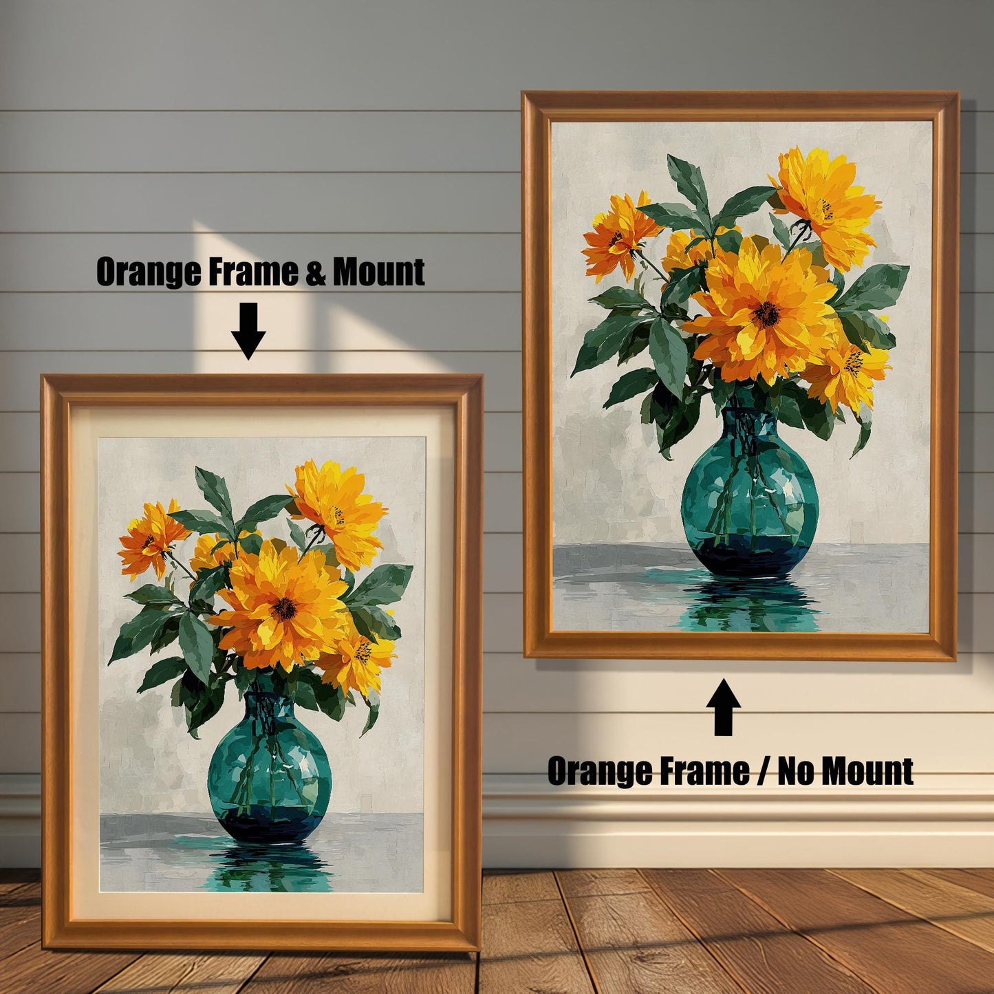 Two framed art prints of yellow flowers in a green vase on a wooden floor. The print on the left is in an orange frame with a mount, and the one on the right is in an orange frame without a mount.