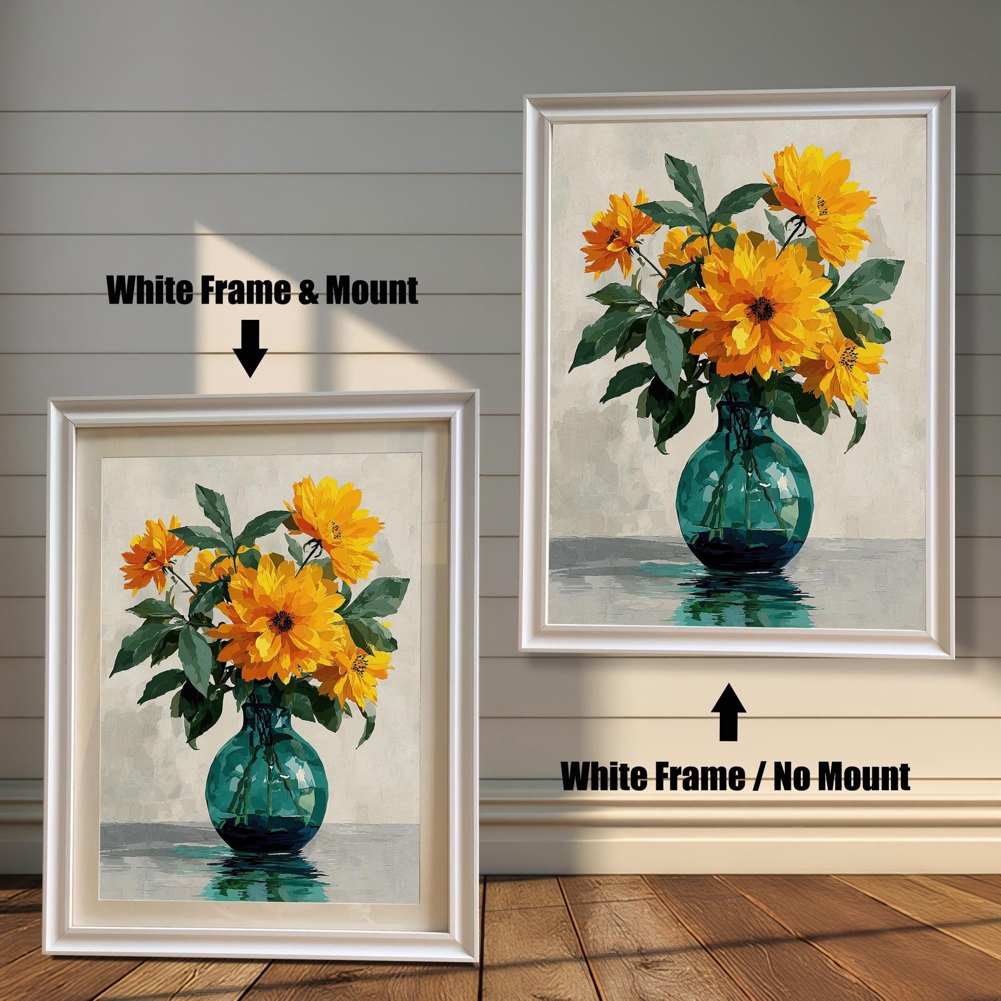 Two framed art prints of yellow flowers in a green vase on a wooden floor. The print on the left is in a white frame with a mount, and the one on the right is in a white frame without a mount.