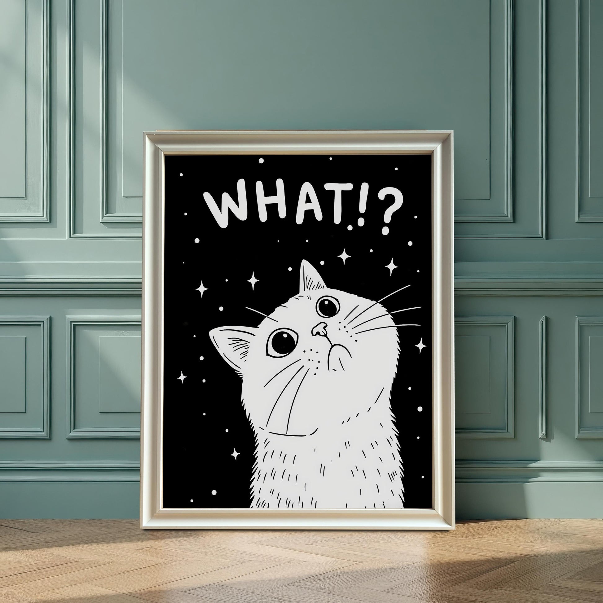 A framed print of a white cat with the text "WHAT!?" sits on a hardwood floor, leaning against a dark teal paneled wall.