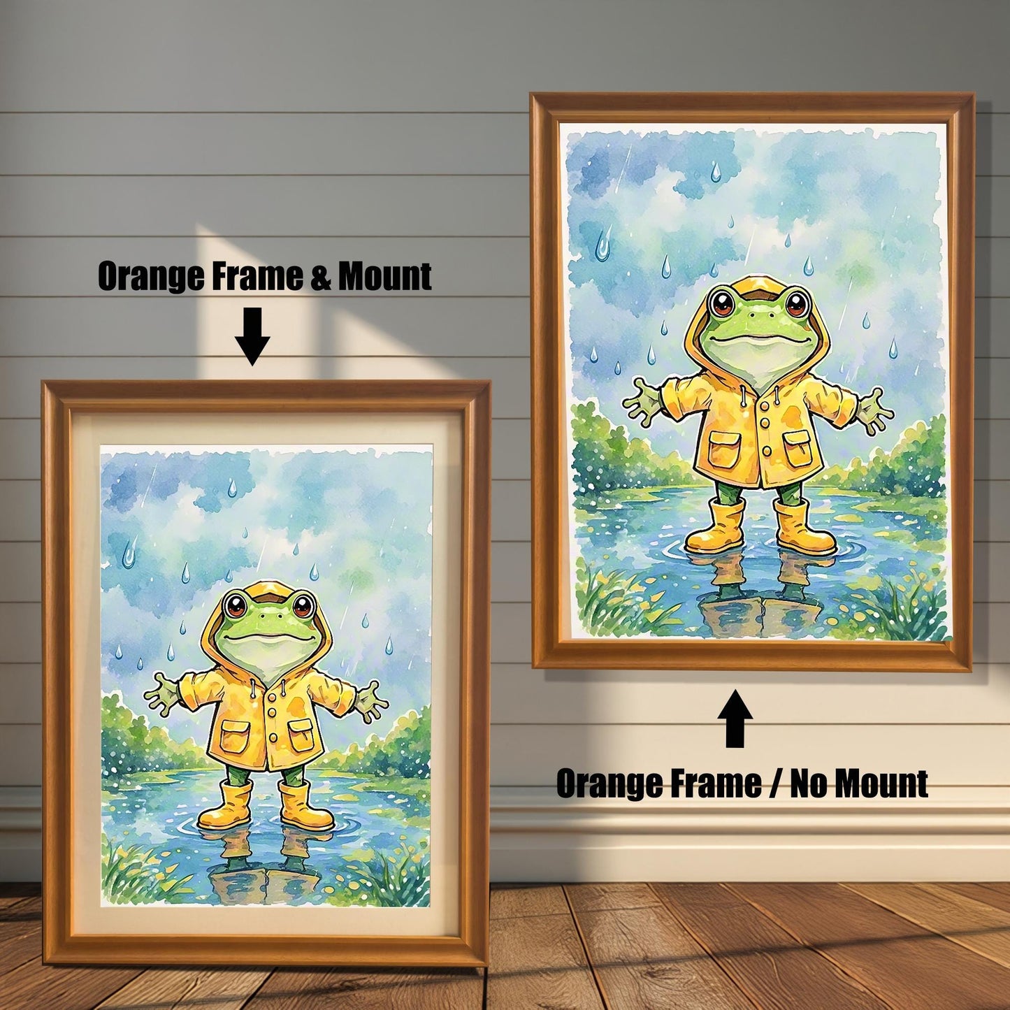 Two framed art prints of a frog in a raincoat. The image on the left has an orange frame with a white mount, while the one on the right has an orange frame with no mount.