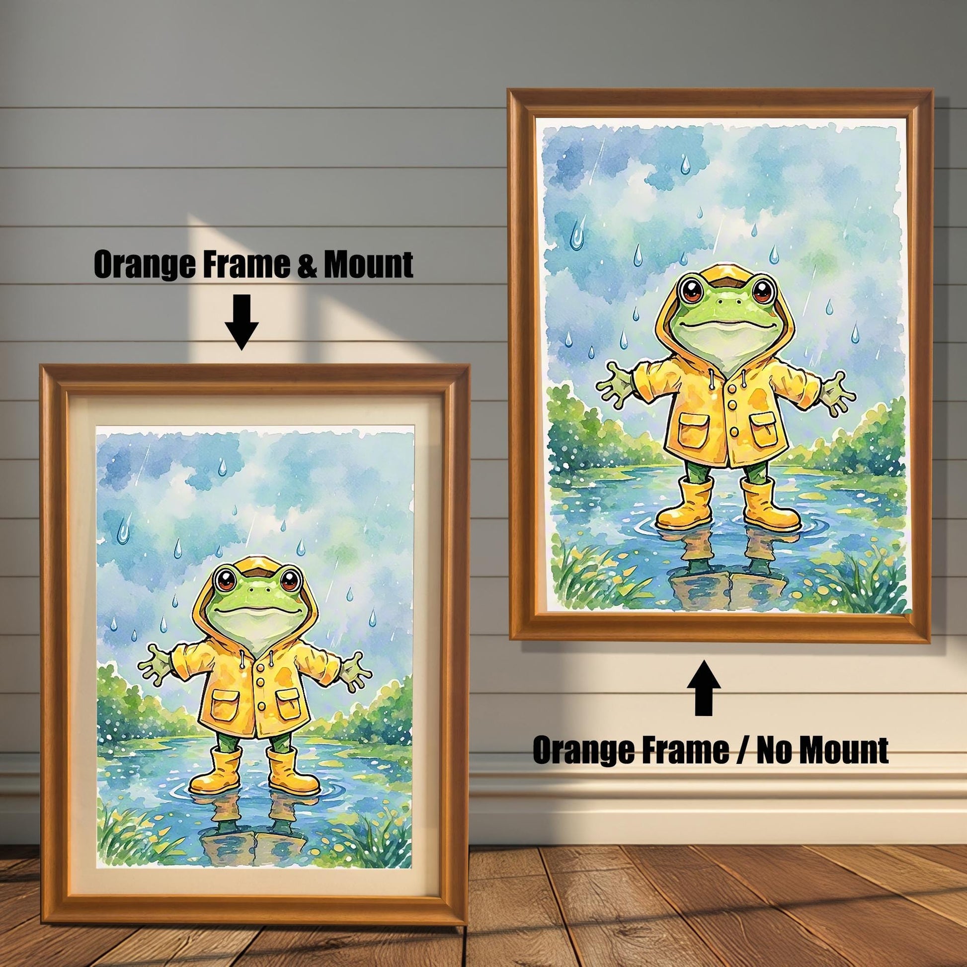 Two framed art prints of a frog in a raincoat. The image on the left has an orange frame with a white mount, while the one on the right has an orange frame with no mount.