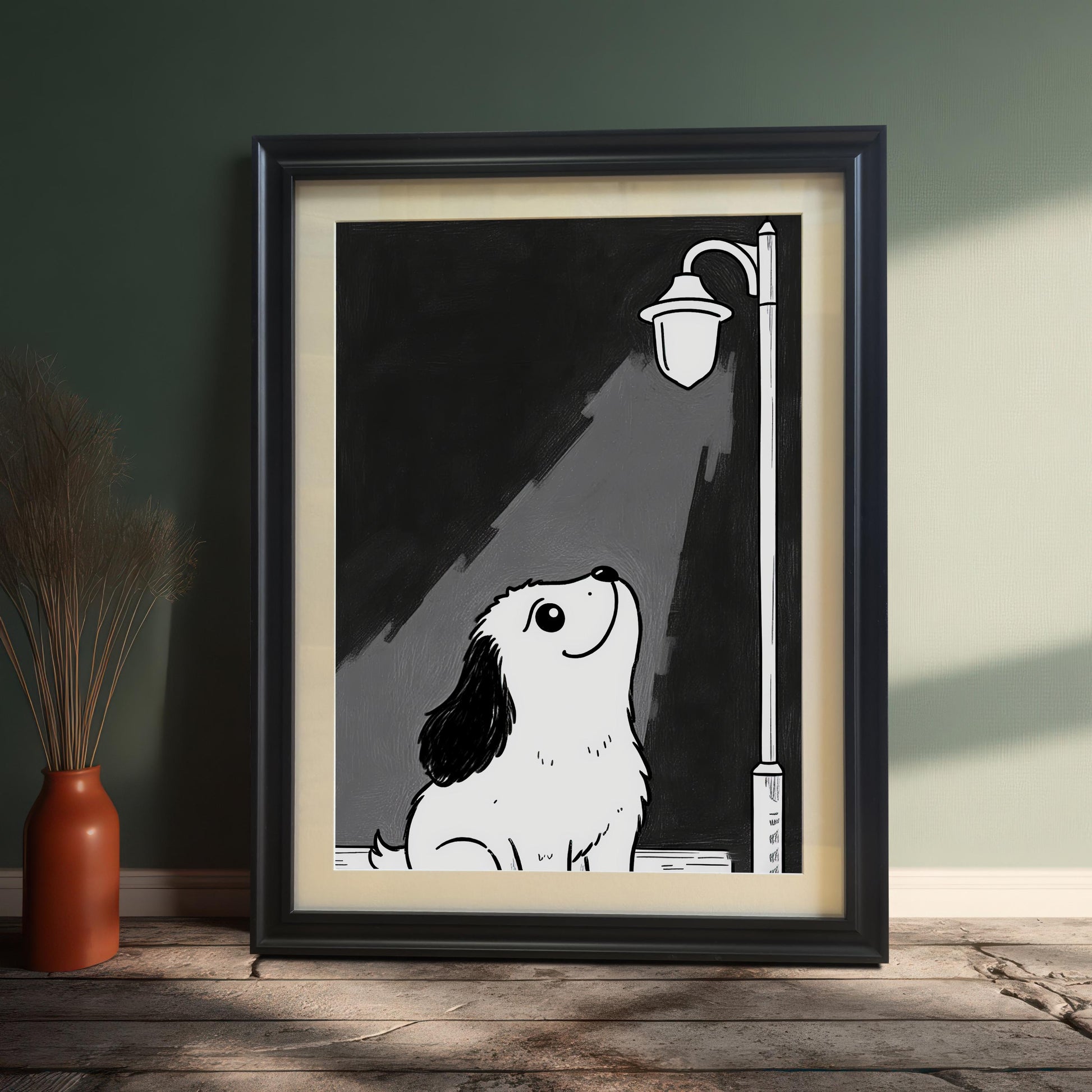 A framed black-and-white print of a cute puppy looking up at a lamppost, leaning against a green wall next to a terracotta vase with dried plants.