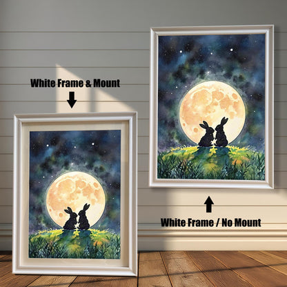 Two framed prints of rabbits under a moon. The one on the left has a "White Frame & Mount," and the right has a "White Frame / No Mount."