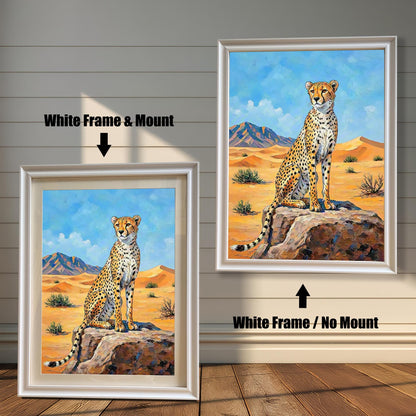 Two framed paintings of a cheetah in a desert. The left one has a white frame with a mount, and the right one has a white frame with no mount.